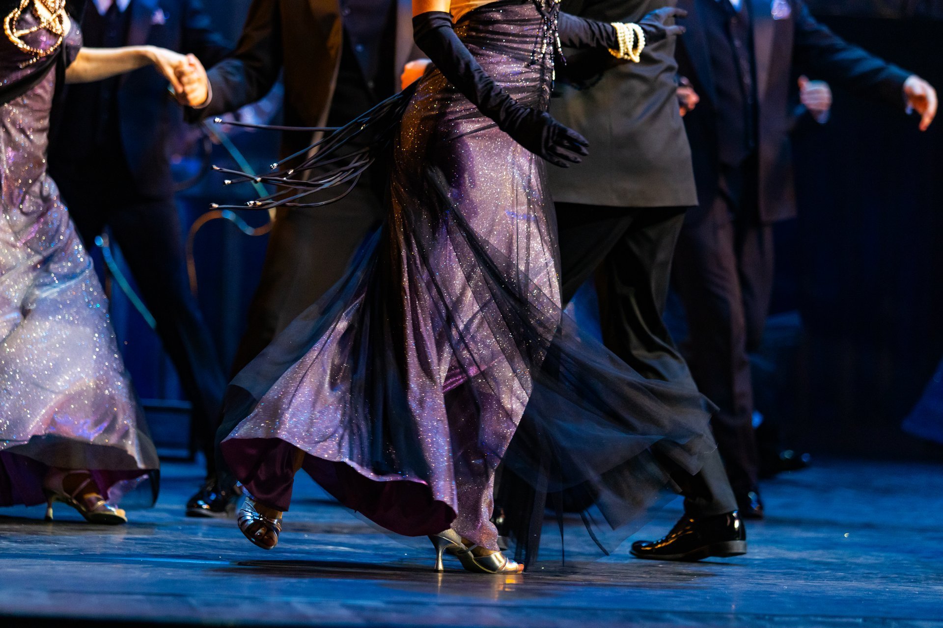 Close up of a couple's feet dancing a waltz on stage