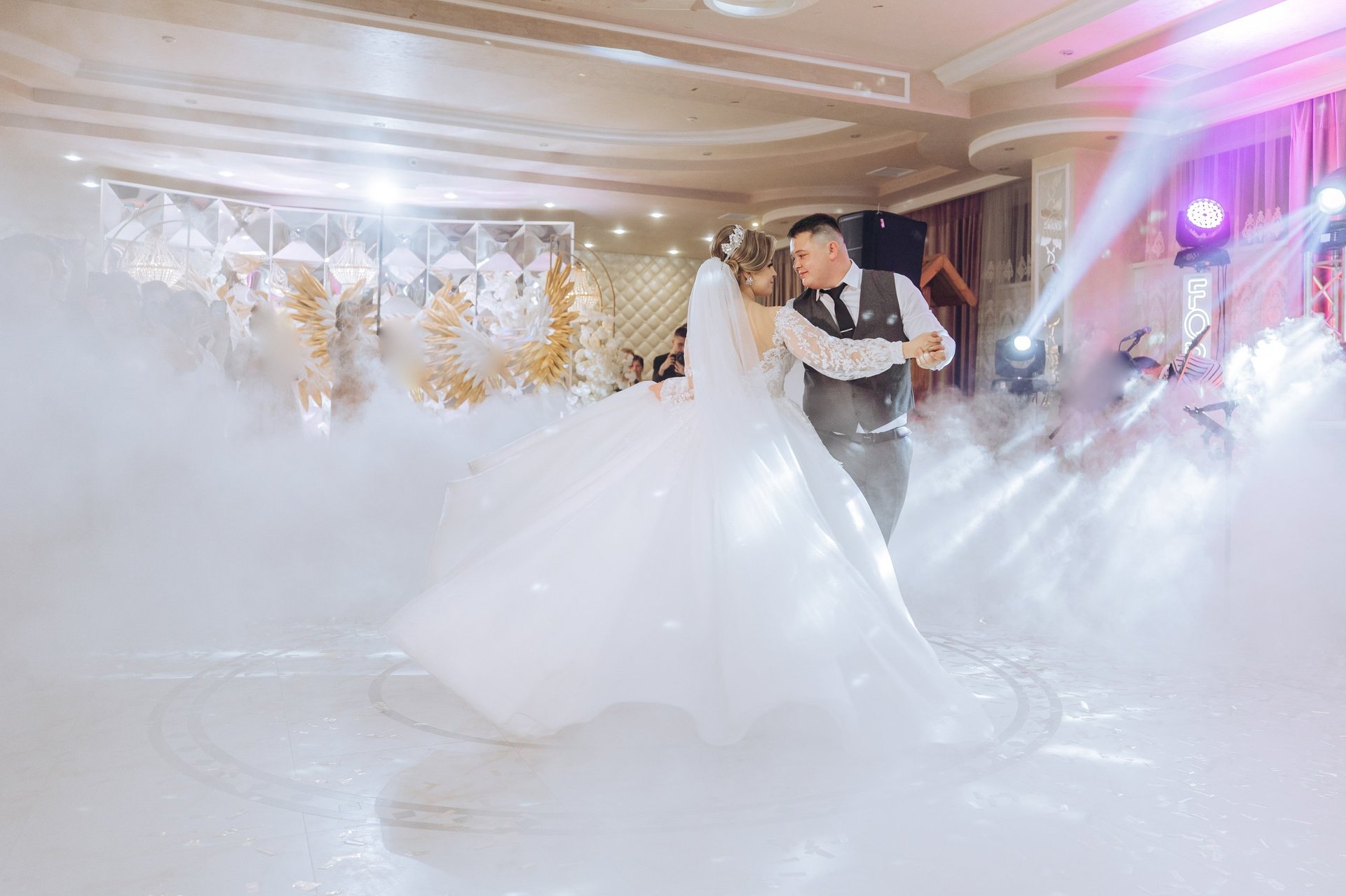 Bride and groom performing elegant first dance at wedding reception