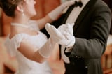 Couple dancing gracefully in formal attire at an elegant event